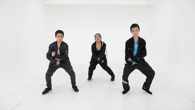 Group of Asian children showing modern dancing and movements having fun on white background
