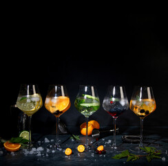 Gin cocktails assortment served on dark background.