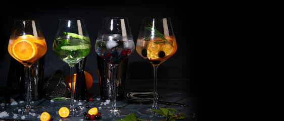 Gin cocktails assortment served on dark background.