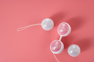 Ben Wa vaginal pleasure balls, Kegel balls on pink background, top view, soft light, empty space...
