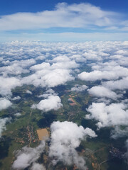 Beautiful clouds on the sky that can also see scenery of the ground. Cabin view from airplane.