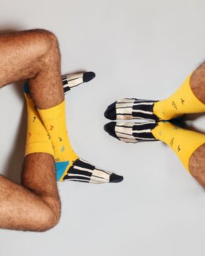 Yellow socks with a happy design. Men's style.