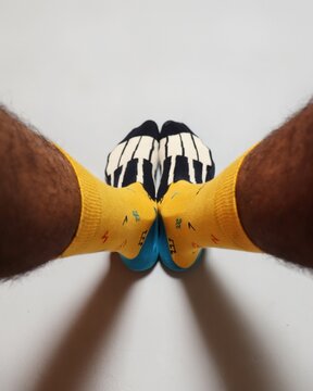The man wears yellow socks with a funny musical design. Men's style