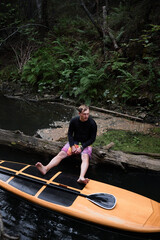 Man taking a break while paddling sup surf on the river