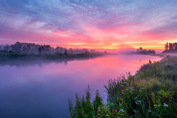 Colorful sunrise over the river banks