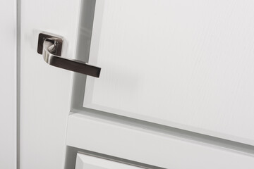 Modern style bronze door handle on white wooden door