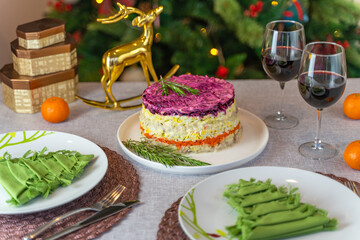 Salad “Herring under a fur coat”.
There are also tangerines and wine on the table. New Year's...
