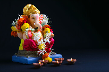 Decorative Lord ganesha sclupture on dark background.