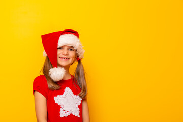 Little girl wearing Santa hat smiling