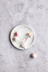 Meringues on a textured ceramic plate