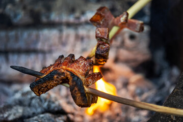 Fototapeta premium Bacon on skewer roasted at fire