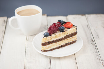 Mix berry cheese cake on white plate on wood background