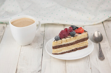 Mix berry cheese cake on white plate on wood background