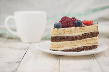 Mix berry cheese cake on white plate on wood background