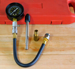 Closeup of a compression tester on the wooden table