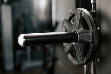 close up view of barbell with disk at gym