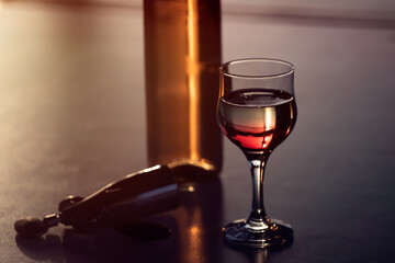Glass of red wine in the sunset.