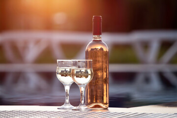 Romantic vacation concept, wine by the swimming pool.