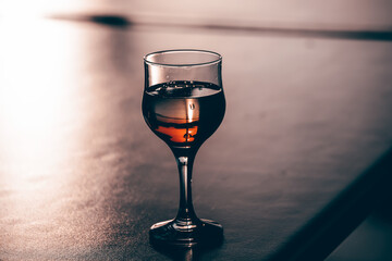 Glass of red wine in the sunset.