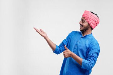 Young indian farmer giving expression on white background