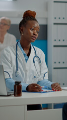 Young medic consulting invalid senior patient for checkup in healthcare office at facility. Elder...