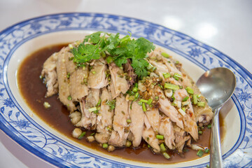 Focus on the steamed chicken with coriander on the plate.