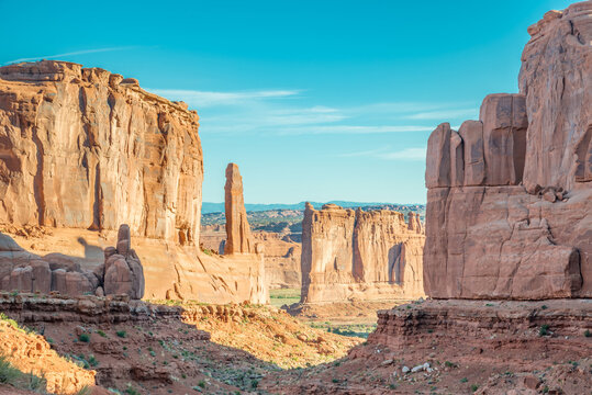Park avenue trailhead at park scenic drive road at Arches National Utah USA. Red rock formations of Arches National Park. Canyon at the feet of the gigantic monoliths of Arches National Park. © naughtynut