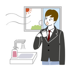 風邪予防でうがいをする男子学生