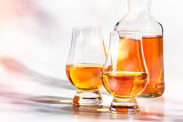 Scotch Whiskey in special glasses and bottle, white background with negative space