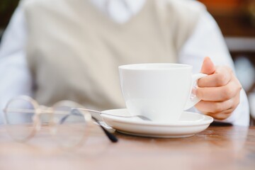 female hands holding a cup of coffee