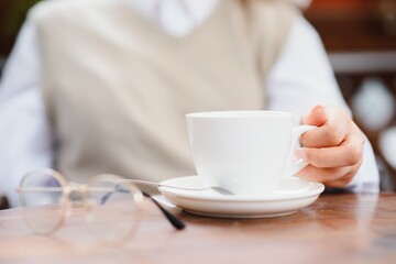 female hands holding a cup of coffee