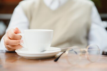 female hands holding a cup of coffee