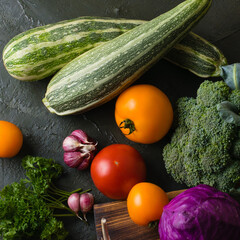 Healthy nutrition concept. Lots of vegetables on a dark table top, view from the top