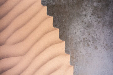 Sand textures background on the beach on a grey basis