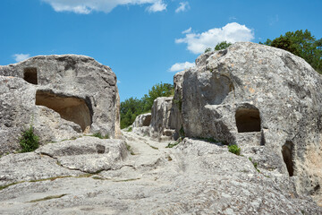 Fototapeta na wymiar Ancient road in the cave city. Medieval fortress-city. Cave mountain town in Crimea.