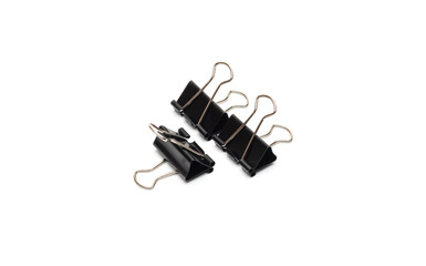 Black metal binder paper clips on an isolated white background