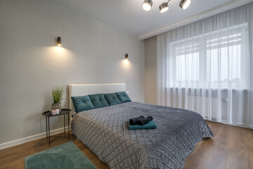 Interior of the modern luxure bedroom in studio apartments in light color style