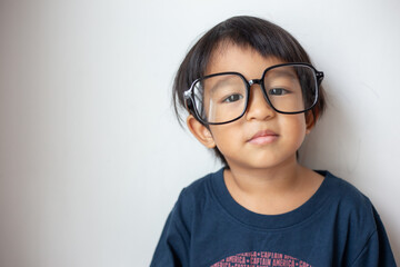 Happy facial face preschool 3 year boy portrait posting on white background