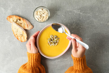 Concept of tasty eating with pumpkin soup, top view