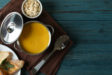 Concept of tasty food with pumpkin soup on wooden table