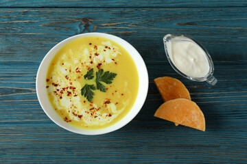 Concept of tasty food with pumpkin soup on wooden table