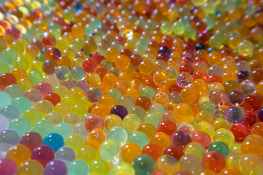 Lots of different colored hydrogel balls. Set of multicolored orbis. Crystal water beads for games. ideal for backgrounds or textures