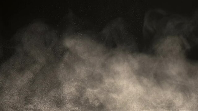 The cloud of particles on the black background. slow motion