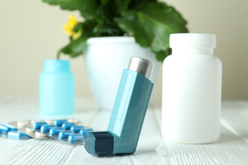 Asthma treatment accessories on white wooden table
