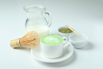 Matcha latte and accessories for making on white background
