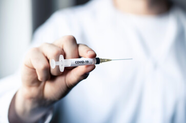 Covid 19 vaccine, corona virus injection and immunization. Doctor or nurse with coronavirus needle...