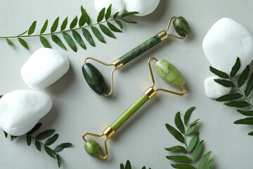 Skin care concept with face rollers on light gray background © Atlas