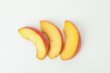 Slices of peach fruit isolated on white background