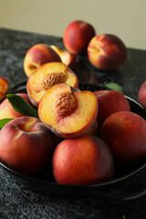 Bowl with peach fruits on black smokey table