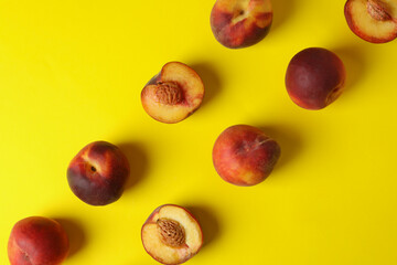 Fresh ripe peach fruits on yellow background